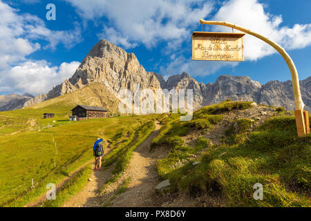 Hiker at Passo San Nicolò Refuge. San Nicolò Pass, Fassa Valley, Trentino, Dolomites, Italy, Europe. Stock Photo