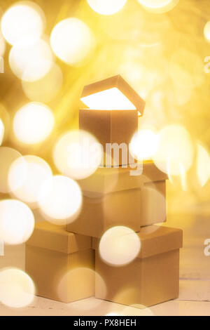 Small cardboard gift boxes with bokeh effect as concept of christmas sale. Stock Photo