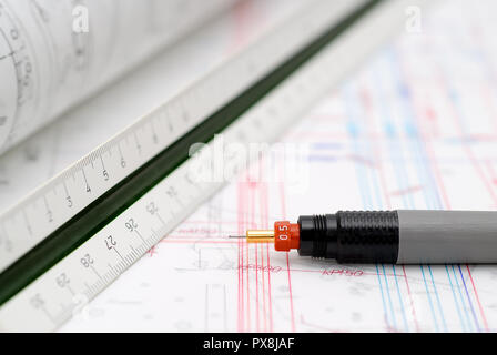 Drawing tools lying on table. Architectural plans in background. Stock Photo