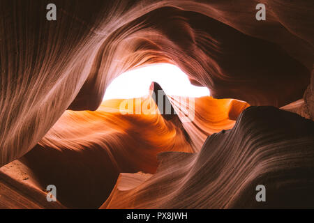 Beautiful wide angle view of amazing sandstone formations in famous Antelope Canyon on a sunny day with blue sky near the old town of Page at Lake Pow Stock Photo