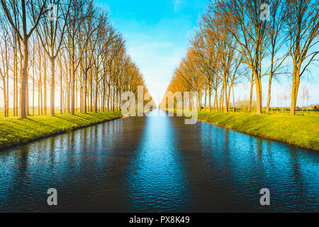 Beautiful view of famous Damme Canal, also known as Damse Vaart or Napoleonvaart, near the city of Brugge in evening light at sunset Stock Photo
