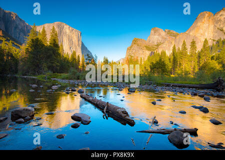 Classic view of scenic Yosemite Valley with famous El Capitan rock climbing summit and idyllic Merced river at sunset, California, USA Stock Photo