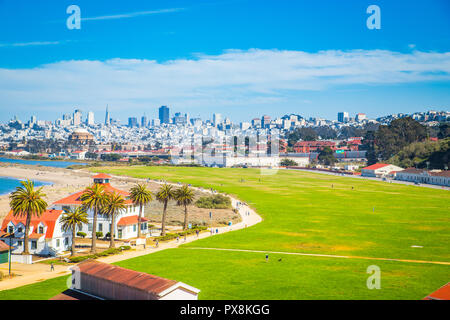 Panoramic view of San Francisco skyline with historic Crissy Field and former USCG Fort Point Life Boat Station (LBS) in the foreground on a beautiful Stock Photo