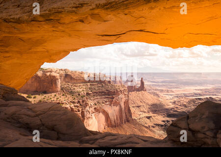 Classic view of famous Mesa Arch, symbol of the American West, illuminated in scenic golden morning light at sunrise on a beautiful day in summer, Can Stock Photo