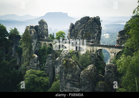 Beautiful panoramic view of famous Bastei Bridge with Elbe Sandstone mountains in Saxon Switzerland National Park on a moody day, Saxony, Germany Stock Photo