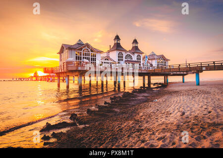 Famous Sellin Seebruecke (Sellin Pier) in beautiful golden morning light at sunrise in summer, Ostseebad Sellin tourist resort, Baltic Sea, Germany Stock Photo