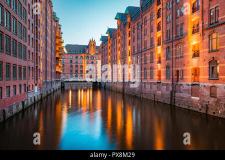 Classic view of famous Speicherstadt warehouse district, a UNESCO World Heritage Site since 2015, illuminated in beautiful post sunset twilight at dus Stock Photo
