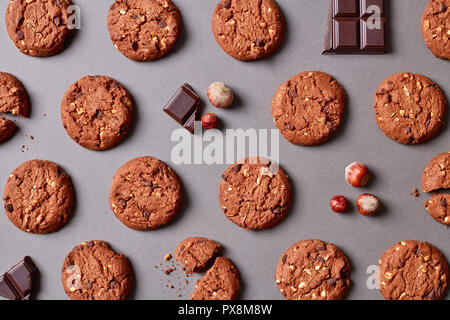 Cookies pattern. Fresh chocolate chips and hazelnut cookies on grey background Stock Photo