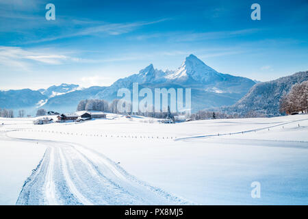 Beautiful winter scenery in the Alps on a cold sunny day with blue sky and clouds Stock Photo