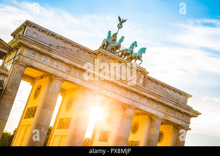 Famous Brandenburger Tor, one of the best-known landmarks and national symbols of Germany, in beautiful golden evening light at sunset, Berlin, German Stock Photo