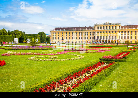 Classic view of famous Schonbrunn Palace with scenic Great Parterre garden on a beautiful sunny day with blue sky and clouds in summer, Vienna, Austri Stock Photo