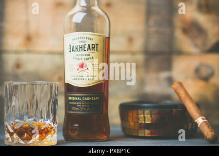 Bottle of Oakheart Bacardi next to a filled crystal glass Stock Photo