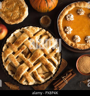 Thanksgiving pumpkin and apple various pies, top view. Fall traditional homemade apple and pumpkin pie for autumn holiday. Stock Photo