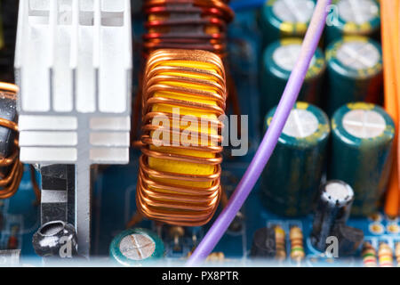 Microchip, capacitors, resistors on a computer board close-up. Industrial background. Stock Photo