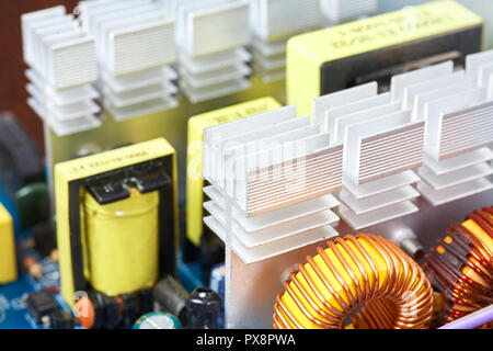 Microchip, capacitors, resistors on a computer board close-up. Industrial background. Stock Photo