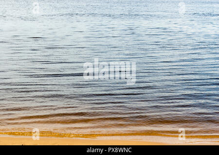 The creek flows into the Volga. Current water and rocks on the bottom. Stock Photo