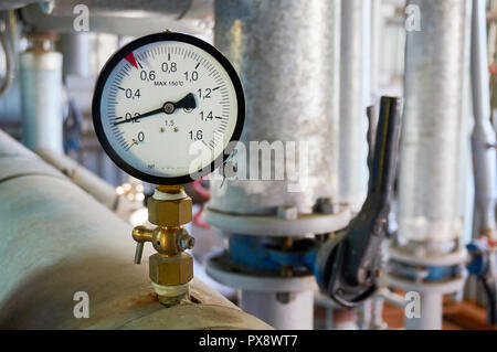 Manometer on the hot water pipeline. Stock Photo