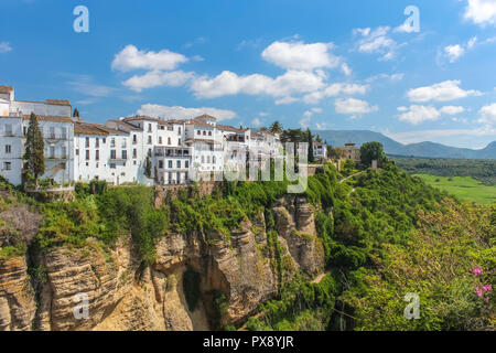 Houses built on the cliffs of beautiful Ronda city, view from 'Puente Nuevo' bridge. Andalusia Spain. Stock Photo
