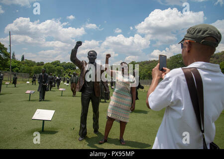 Pretoria, South Africa, 20 October, 2018. A couple takes selfies with a sculpture of struggle hero Steve Biko. The artwork forms part of The Long March to Freedom National Heritage Monument, in Pretoria's Groenkloof Nature Reserve. Nearby is a sculpture of Albertina Sisulu, who would have celebrated her 100th birthday tomorrow, 21 October. Nontsikelelo Albertina Sisulu is joined by her late husband Walter Sisulu in the sculpture. Credit: Eva-Lotta Jansson/Alamy Live News Stock Photo