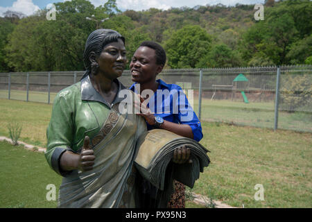 Pretoria, South Africa, 20 October, 2018. A visitor shows her appreciation for a sculpture of Rahima Moosa, known for leading the uprising of women against pass laws in 1956. The artwork forms part of The Long March to Freedom National Heritage Monument, in Pretoria's Groenkloof Nature Reserve. Nearby is a sculpture of Albertina Sisulu, who would have celebrated her 100th birthday tomorrow, 21 October. Nontsikelelo Albertina Sisulu is joined by her late husband Walter Sisulu in the sculpture. Credit: Eva-Lotta Jansson/Alamy Live News Stock Photo
