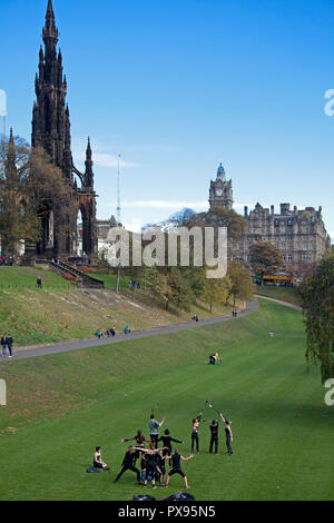 Edinburgh, Scotland, UK. 20th Oct, 2018. Performers practice in Princes Street Gardens East for the forthcoming event on Calton Hill the Samhuinn Fire Festival this event on Hallowe'enwill mark the transition from Winter to Summer with characteristic mix of fireplay, drumming, and immersive performance. Also, people can be seen relaxing in the gardens with some of the stumps of the recently felled 52 trees which some of the locals have branded 'An Absolut Disgrace', this is part of landscaping works and an extension at Scottish National Gallery backed by the Edinburgh council. Stock Photo