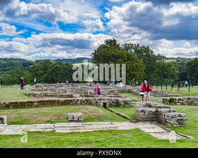 11 August 2018: Tourists viewing the excavated ruins of Chesters Roman Fort, Hadrian's Wall, Northumberland, UK Stock Photo