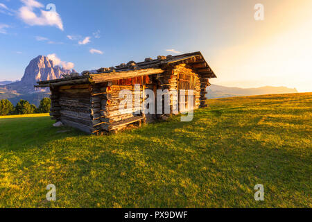 Last rays of sun on traditional hut with view on Sassolungo Group. Gardena Valley, South Tyrol, Dolomites, Italy, Europe. Stock Photo