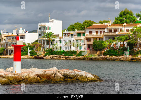 Buildings an navigational light at the harbour of Porto Petro, Mallorca. Stock Photo