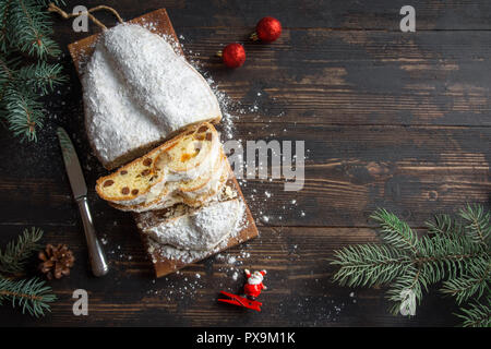 Christmas stollen on wooden background. Traditional Christmas festive pastry dessert. Stollen for Christmas. Stock Photo