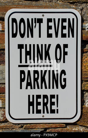 no parking sign with a funny English text: Don´t even think of parking here Stock Photo