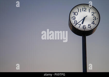 Analogue clock on pole Stock Photo