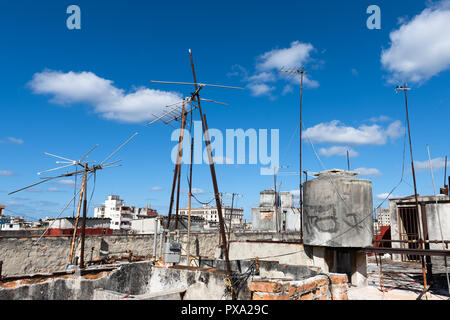 Antennas on the roofs against a blue sky Stock Photo