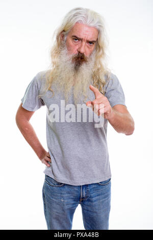 Studio shot of angry senior bearded man pointing at camera Stock Photo