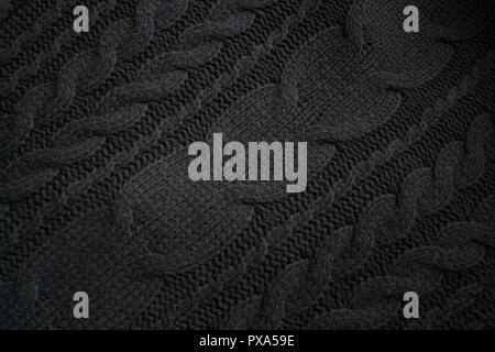 Black woolen knitted textile detail with diagonal patterns Stock Photo