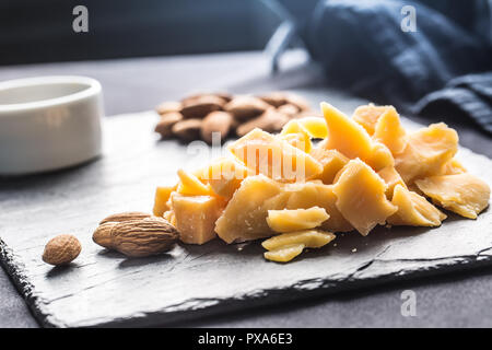 Close-up Cheese pieces and nuts on slate board. Stock Photo