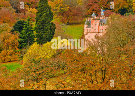 CRAIGIEVAR CASTLE ABERDEENSHIRE SCOTLAND PINK CASTLE TOWER SURROUNDED BY BEECH TREE LEAVES IN AUTUMN Stock Photo