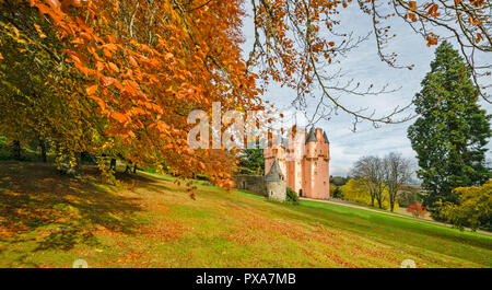 CRAIGIEVAR CASTLE ABERDEENSHIRE SCOTLAND THE PINK CASTLE SURROUNDED BY SUNLIT BEECH TREE LEAVES IN AUTUMN Stock Photo