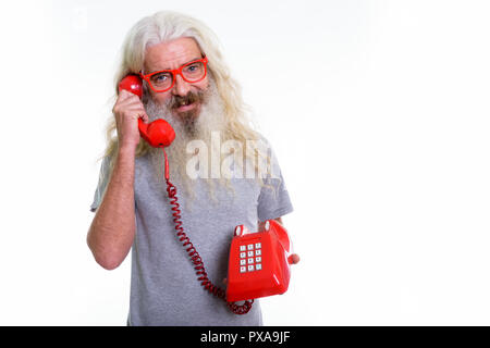 Studio shot of happy senior bearded man smiling while talking on Stock Photo