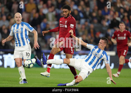 Liverpool's Joe Gomez (centre) and Huddersfield Town's Jonathan Hogg battle for the ball during the Premier League match at the John Smith's Stadium, Huddersfield. Stock Photo