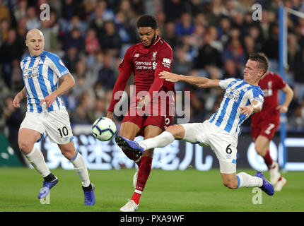 Liverpool's Joe Gomez (centre) and Huddersfield Town's Jonathan Hogg battle for the ball during the Premier League match at the John Smith's Stadium, Huddersfield. Stock Photo