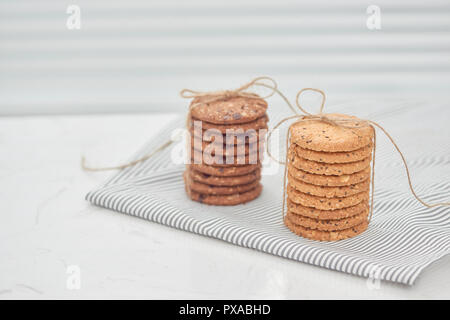 Cookie are stack and tied with twine. Delicious cookies on napkin background. Homemade cake. The nut cookie. Stock Photo