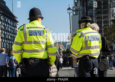 Police (Bobbies) wearing high vis jackets on the beat in Parliament Square, Westminster, London, UK Stock Photo