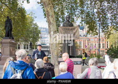 A walking tour at 'Courage calls to courage everywhere'  - Gillian Wearing’s statue of Millicent Fawcett in Parliament Square, London, England, UK Stock Photo