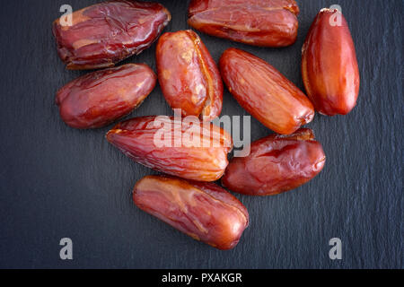 Dates Fruit on a Black Slate Background. Close up. Stock Photo