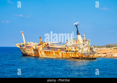 Abandoned rusty ship wreck EDRO III in Pegeia, Paphos, Cyprus. It is stranded on Peyia rocks at kantarkastoi sea caves, Coral Bay, Pafos, standing at  Stock Photo