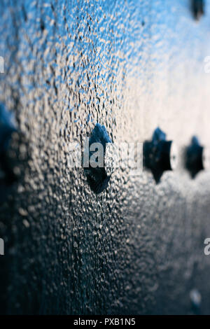Close up on an old metal Bolt painted in green. abstract. Vertical Stock Photo