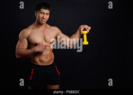 trainer is showing bodybulders' tool Stock Photo