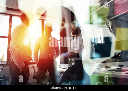 Business people work together in office. Concept of teamwork and partnership. double exposure with light effects Stock Photo