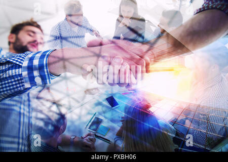Handshaking business person in casual wear in the office. concept of teamwork and partnership. double exposure Stock Photo
