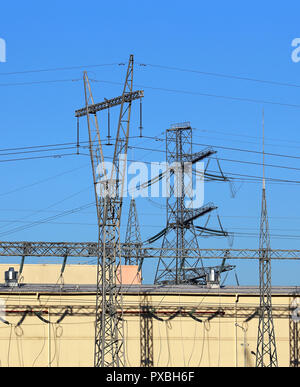 Large industrial facility with high-voltage power transmission lines Stock Photo